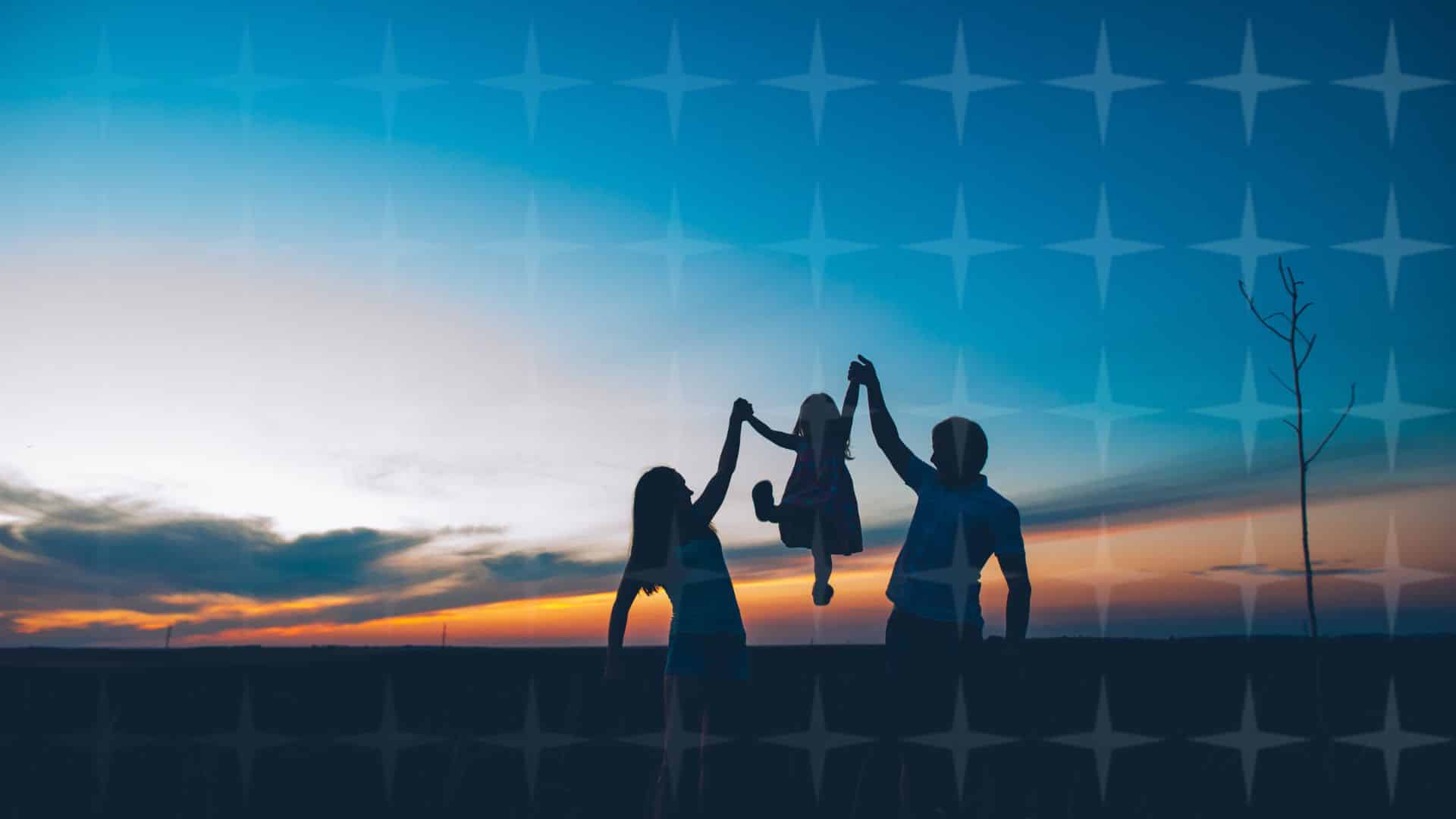 Silhouette of mother, father and child in front of a sunset.